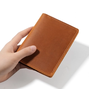 Brown crazy horse leather passport holder wallet with visible yellow stitching detail