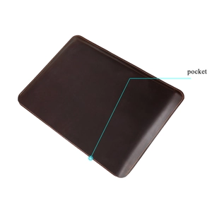 Detail of premium brown leather MacBook Pro case showing stitched pocket and fine texture