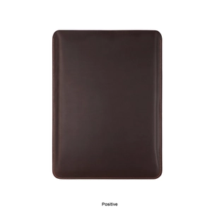Detailed view of dark brown leather sleeve for MacBook Pro with premium orange stitching