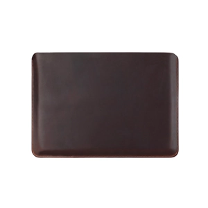 Detailed macro view of deep brown leather sleeve with yellow stitching for MacBook Pro 14.2