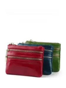 Detailed view of genuine leather coin purses with three zipper compartments in various colors