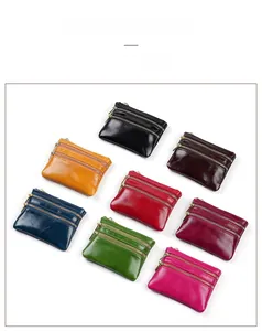 Detailed view of eight colorful oil wax leather coin purses with triple gold zippers