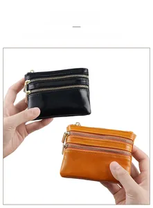Close-up of compact oil wax leather wallets with three-layer golden zippers