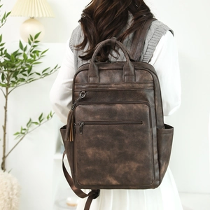 Vintage dark brown PU leather backpack with large capacity and stylish tassels worn by model