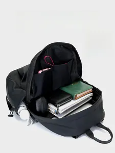 Internal view of a black laptop backpack showing multi-layered storage for a 15.6 inch laptop