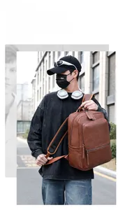 Brown PU leather backpack with lychee texture and breathable mesh straps shown on model