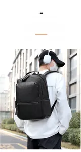 Men's matte leather business backpack shown in an outdoor lifestyle street photography view