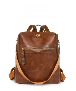 Detailed front view of brown vintage leather backpack with golden zipper and pebble texture