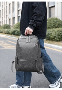 Detail of grey PU leather business backpack with front zipper and side bottle pocket