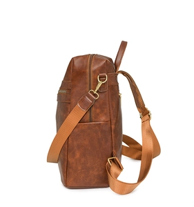 Detail view of vintage brown backpack showing high-quality PU leather and metal zippers