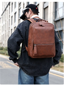 Deep brown PU leather business backpack worn by model showing size and urban style