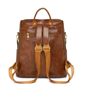 Detail view of the vintage brown PU leather backpack back with secure zipper pocket