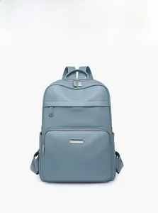 Detailed front view of light blue lychee pattern leather backpack for women showing texture