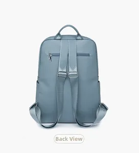Back view of a blue leather backpack with anti-theft zipper pocket and padded straps
