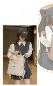 Detail of off-white lychee grain faux leather backpack with silver metal logo plate
