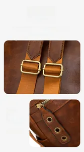 Detail view of vintage brown leather bag with golden buckles and metal zipper rings