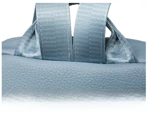 Close-up of light blue leather backpack with reinforced nylon straps and durable stitching