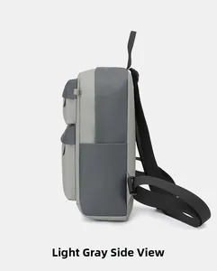 Side view of lightweight two-tone grey sports backpack with storage pockets and stitching