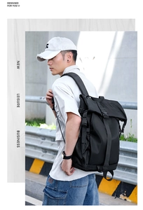 Side view of black roll-top tactical backpack with buckles and functional side mesh pockets