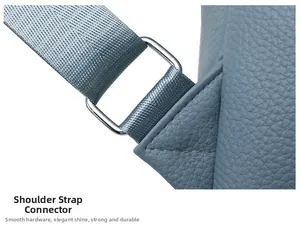 Detailed macro view of blue lychee grain leather texture with silver metal buckle and strap