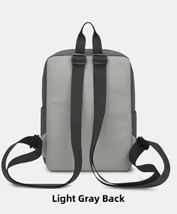 Rear view of a lightweight light grey patchwork sports backpack with black nylon straps