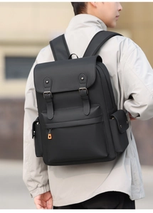 Outdoor shot showing wide padded straps and multi-pocket design of the vintage backpack