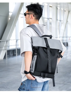 Modern black and gray flap-top motorcycling backpack with durable buckle and side straps
