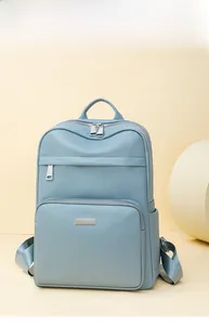 Detail of light blue lychee pattern leather backpack with functional multi-zone pockets