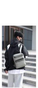 Outdoor lifestyle shot of a lightweight minimalist grey sports backpack with two zip pockets