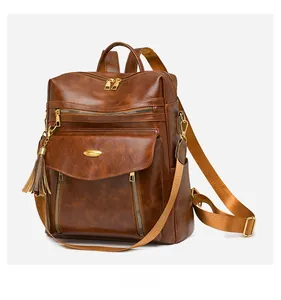 Detail view of brown vintage PU leather backpack with gold hardware and side pocket