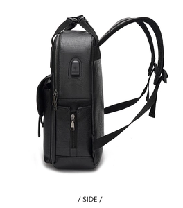 Side view of black pebble leather backpack featuring a built-in USB charging port and side pocket