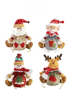 Detail view of four Christmas drawstring bags with Santa, Elf, Snowman, and Reindeer dolls