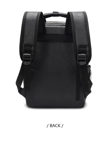 Back view of black leather backpack showing wide shoulder straps and anti-theft zip pocket