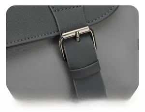 Detailed view of dark grey metallic pin buckle and textured faux leather strap