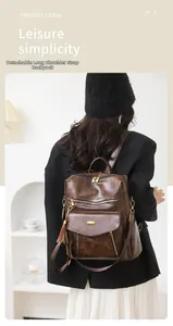 Detail of dark brown vintage PU leather backpack with fringe and adjustable straps