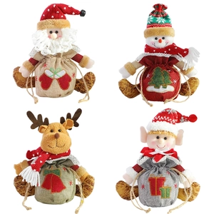 Set of four Christmas drawstring gift bags featuring plush Santa, Snowman, Deer and Boy