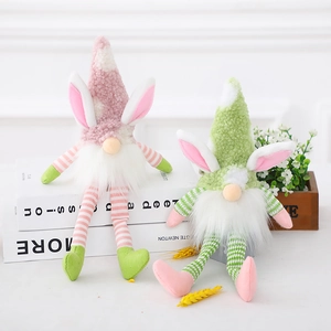 Easter gnome plush toys with bunny ears and long striped legs sitting on white books