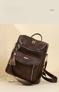 Macro view of vintage brown PU leather texture and gold metal hardware on backpack