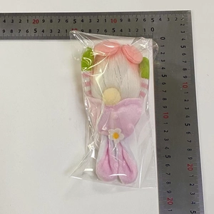 Detail of plush Easter gnome pendant with pink bow and white hair measuring 18-20cm