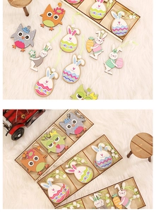 Detail of Easter wooden rabbit and owl pendants in a gift box with rustic decor