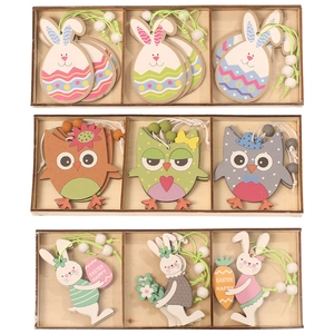 Easter painted wooden bunny and owl ornaments set in a rustic storage box display