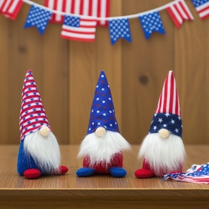 Three USA Independence Day gnomes with stars and stripes on a rustic wooden table