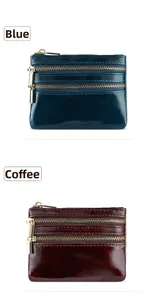 Detail of blue and coffee oil-wax leather coin pouches with triple gold zippers