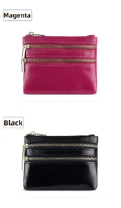 Detail showing stacked black and rose red leather coin purses with three golden zippers