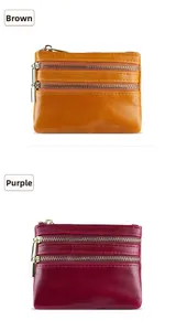 Detail of genuine leather coin purses with three zipper pockets in brown and purple
