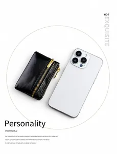 Dettaglio che mostra le dimensioni compatte di un portamonete in pelle nera e smartphone