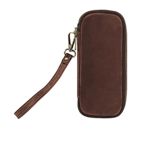 Macro shot of dark brown vintage leather pipe storage pouch with a brass hook wrist strap