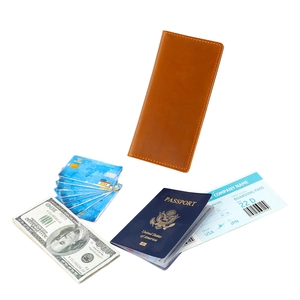 Detailed view of brown leather travel wallet with hand-stitched edges and card slots