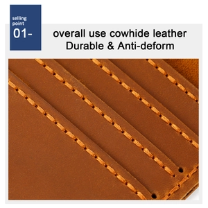 Macro shot of durable brown cowhide leather with precise orange stitching on a long wallet