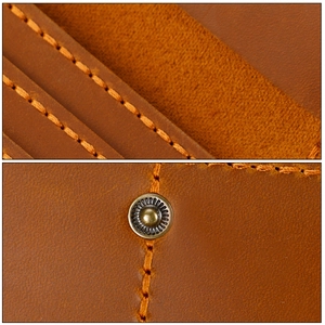 Macro detail of handmade stitching and bronze snap button on crazy horse leather wallet